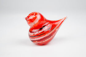 red glass bird with cremation ash from pets and people