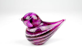 purple glass bird with cremation ash from pets and people