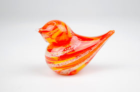 orange glass bird with cremation ash from pets and people