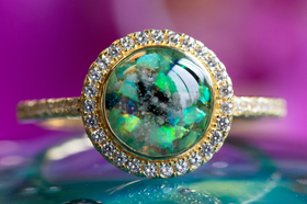 Photo depicts our Bedazzled Circle Opal Cremation Ring, in the colors green and black, sitting on a glass surface. Sterling Silver Ring, Sterling Silver Ring for Ash, Ring for Cremation Ash, Sterling Silver Remembrance Jewelry, Sterling Silver and Cubic Zirconia Ring